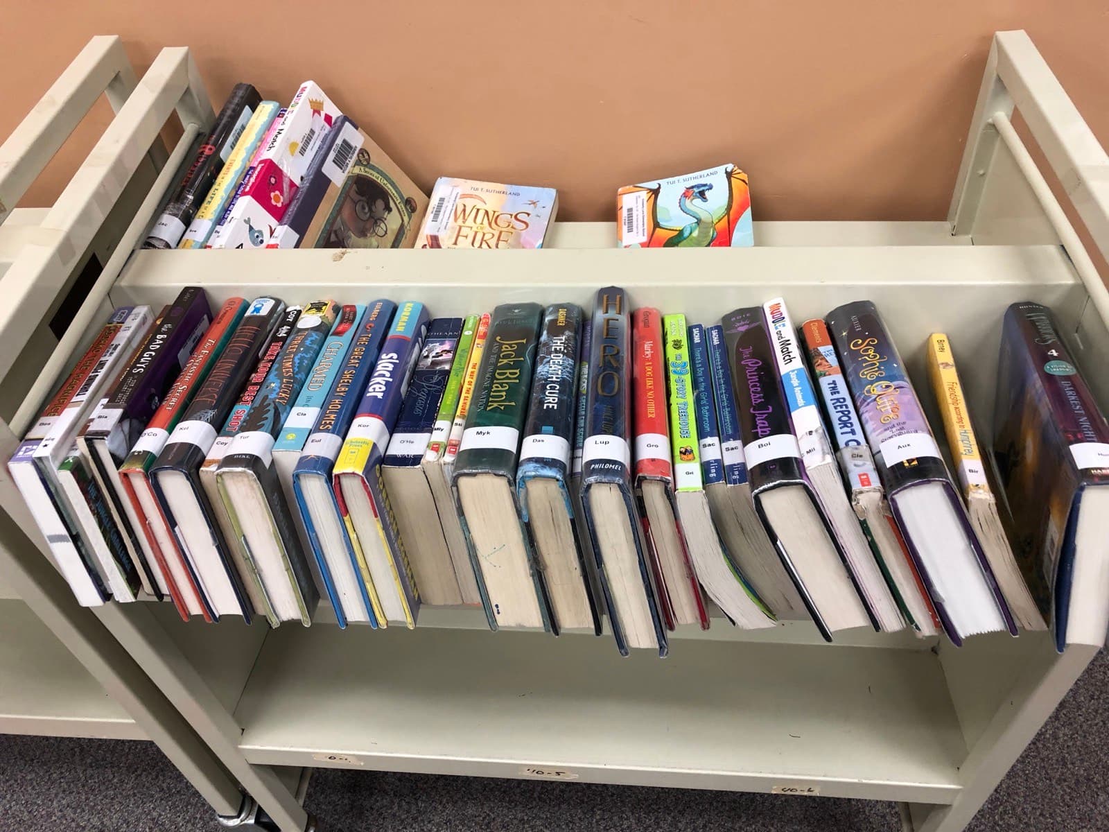 A library cart loaded with withdrawn books
